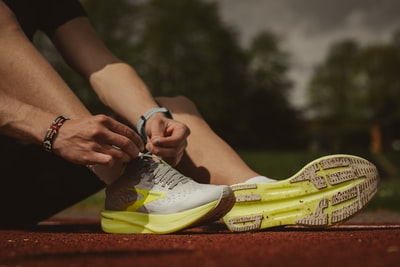 person putting on running shoes to help show example of keyword phases example