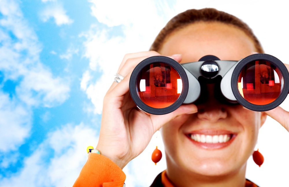business search - woman looking through binoculars