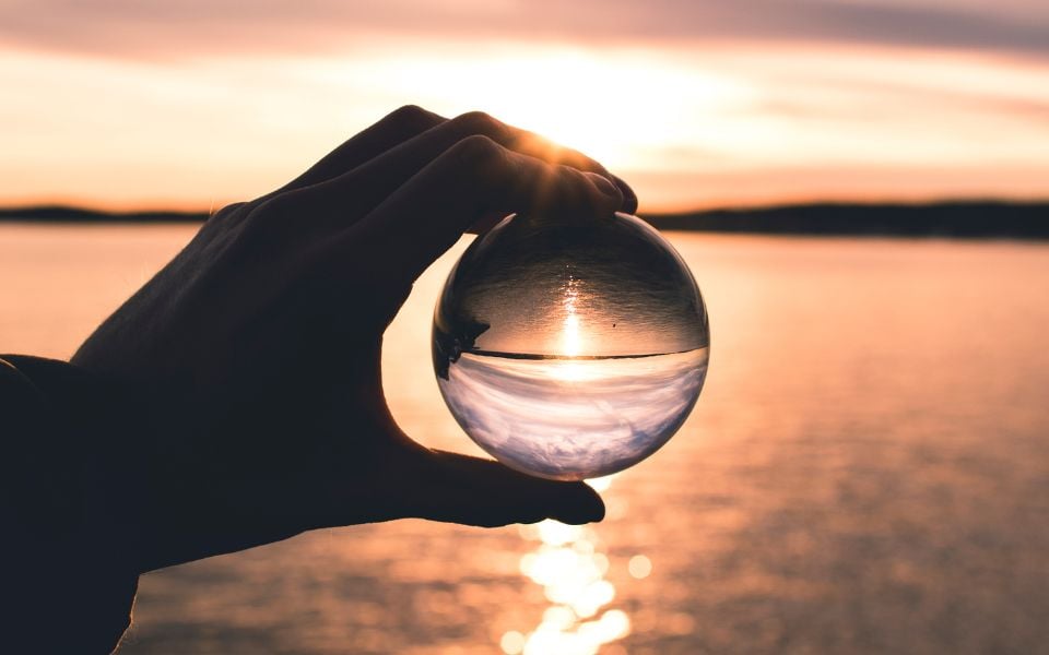 person looking into a crystal ball